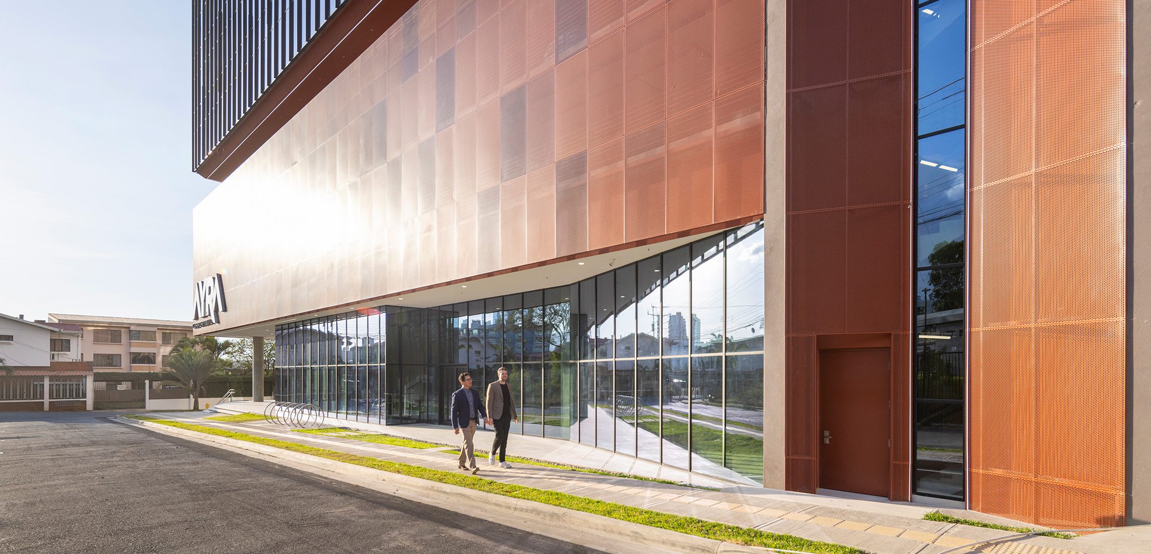 building and two coworkers walking